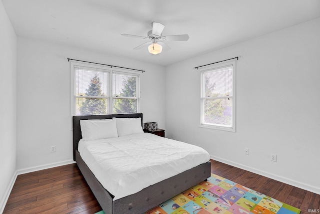 bedroom with baseboards, a ceiling fan, and wood finished floors