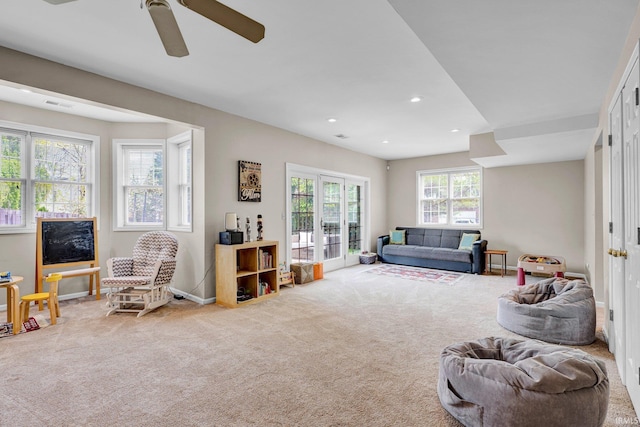 living room featuring visible vents, baseboards, recessed lighting, a ceiling fan, and carpet
