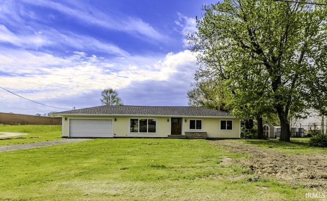 ranch-style house featuring an attached garage, driveway, and a front lawn