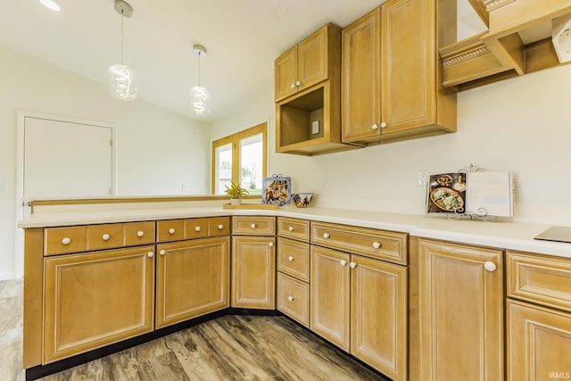 kitchen featuring hanging light fixtures, open shelves, wood finished floors, light countertops, and a peninsula