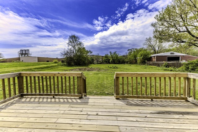 wooden terrace featuring a lawn
