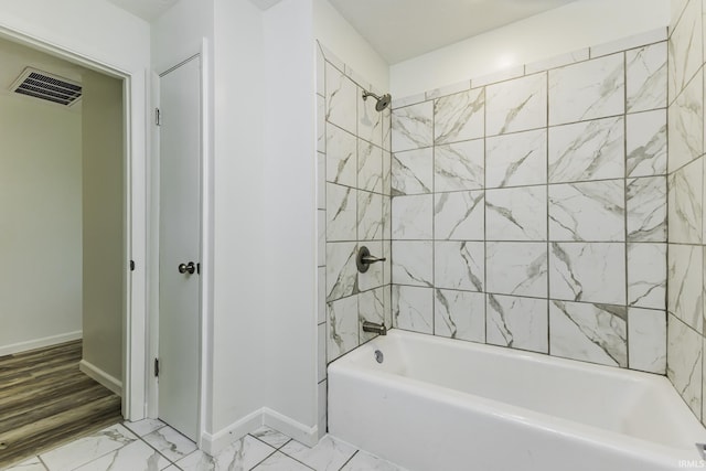 full bath featuring visible vents, marble finish floor, baseboards, and shower / tub combination