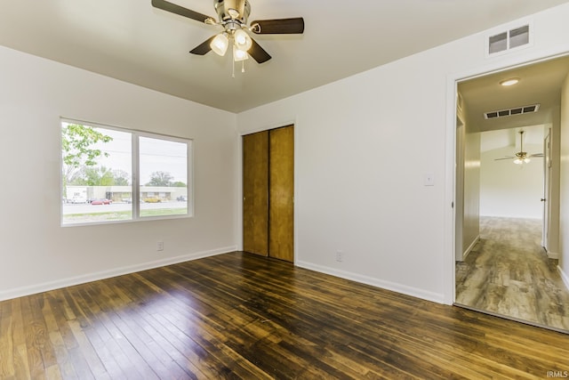 unfurnished bedroom with visible vents, baseboards, and hardwood / wood-style floors