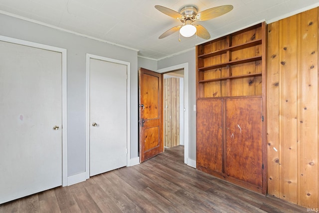 unfurnished bedroom with crown molding, baseboards, ceiling fan, and wood finished floors