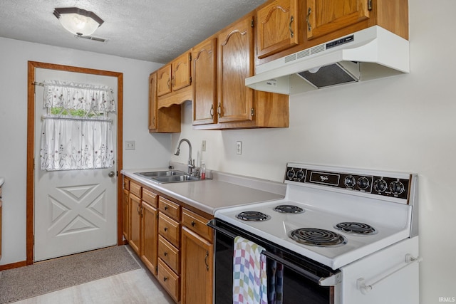 kitchen with visible vents, range with electric stovetop, light countertops, under cabinet range hood, and a sink