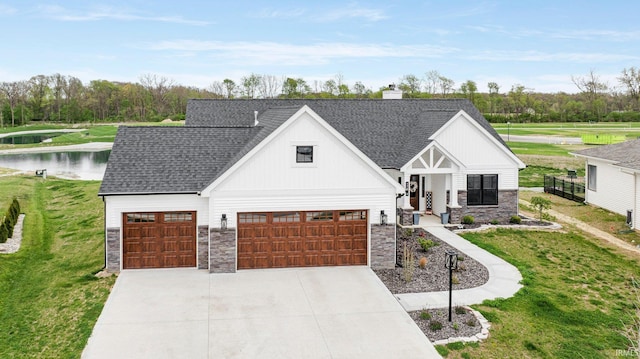 modern farmhouse featuring board and batten siding, a water view, a front lawn, and stone siding
