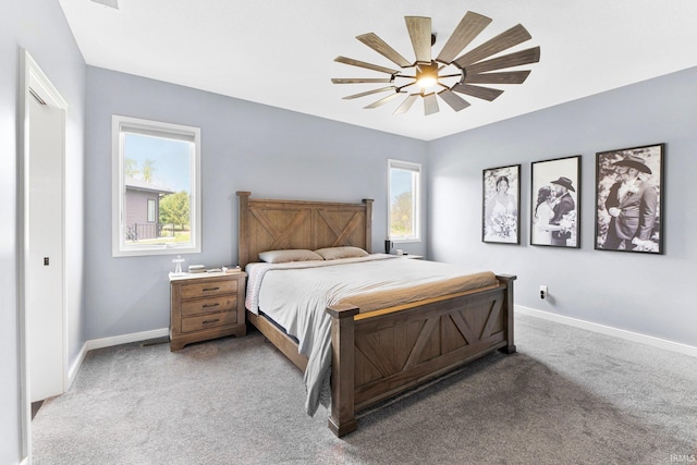 bedroom with a ceiling fan, baseboards, and light colored carpet