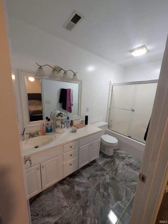 4090 Pinehurst Dr, Jasper, IN 47546 - full bathroom featuring bath / shower combo with glass door, vanity, ensuite bath, toilet, and marble finish floors