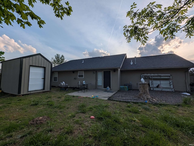 4090 Pinehurst Dr, Jasper, IN 47546 - back of house with a lawn, an outdoor structure, a patio area, and a shed