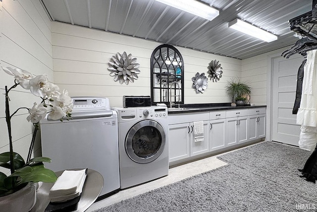 55960 County Road 23, Bristol, IN 46507 - clothes washing area with washing machine and clothes dryer, cabinet space, a sink, carpet floors, and wood walls