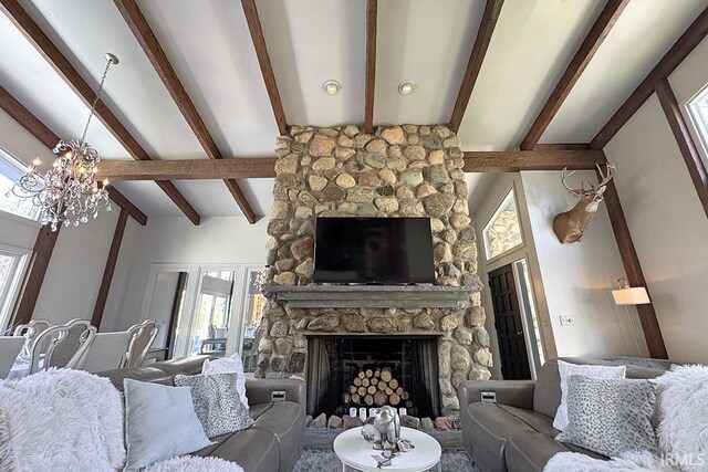 55960 County Road 23, Bristol, IN 46507 - living room with beamed ceiling, a chandelier, a stone fireplace, and a wealth of natural light