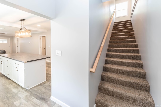 stairs with recessed lighting, baseboards, and wood finished floors