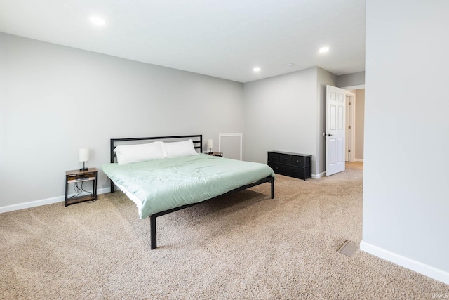 carpeted bedroom featuring baseboards and recessed lighting