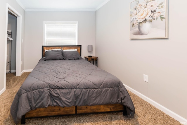 carpeted bedroom featuring crown molding and baseboards