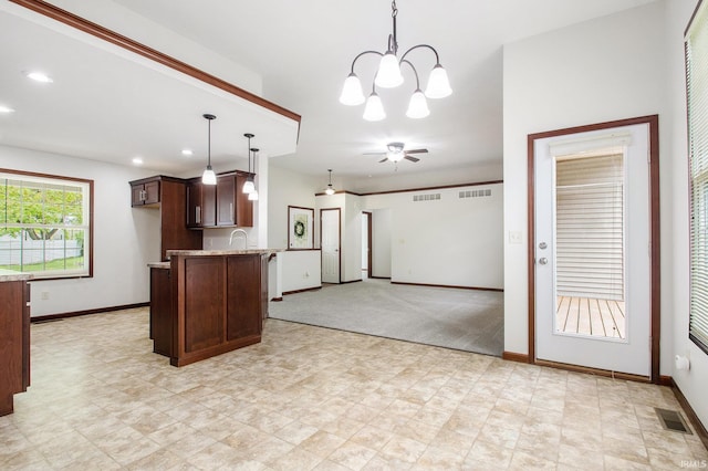 300 E Wabash Ave, Wakarusa, IN 46573 - kitchen with dark brown cabinets, baseboards, recessed lighting, a sink, and hanging light fixtures