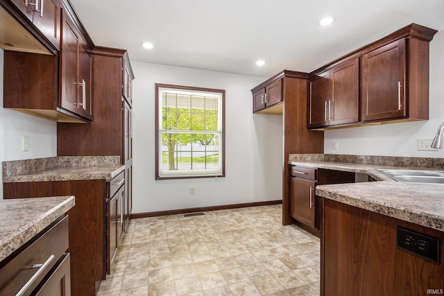 300 E Wabash Ave, Wakarusa, IN 46573 - kitchen featuring visible vents, a sink, baseboards, and recessed lighting