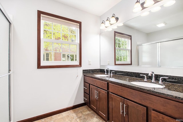 300 E Wabash Ave, Wakarusa, IN 46573 - bathroom featuring baseboards, a sink, a shower with door, and double vanity