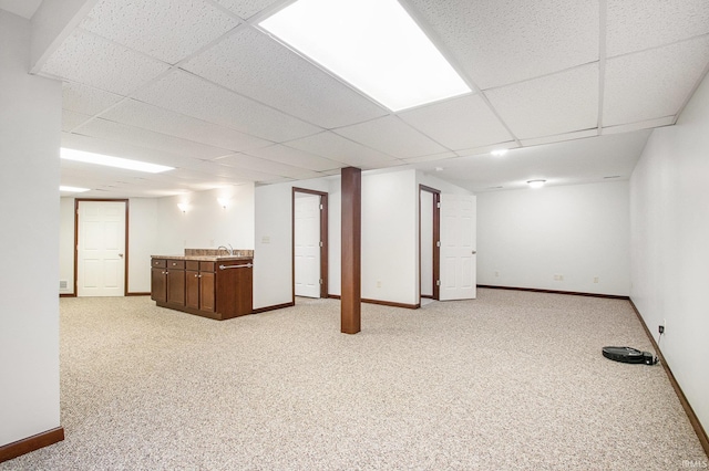 300 E Wabash Ave, Wakarusa, IN 46573 - finished basement with baseboards, a drop ceiling, light colored carpet, a sink, and bar area