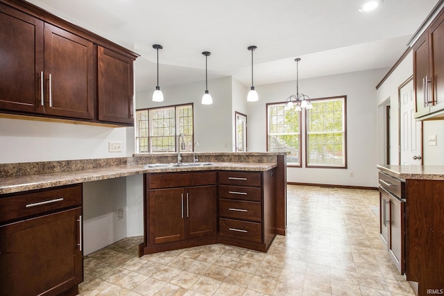 300 E Wabash Ave, Wakarusa, IN 46573 - kitchen featuring a peninsula, dark brown cabinetry, hanging light fixtures, and a sink