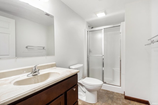 300 E Wabash Ave, Wakarusa, IN 46573 - full bath featuring stone finish floor, visible vents, a stall shower, vanity, and toilet