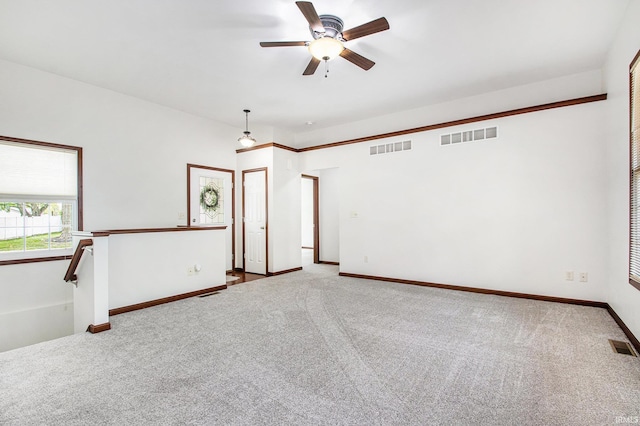 300 E Wabash Ave, Wakarusa, IN 46573 - spare room featuring ceiling fan, visible vents, and carpet
