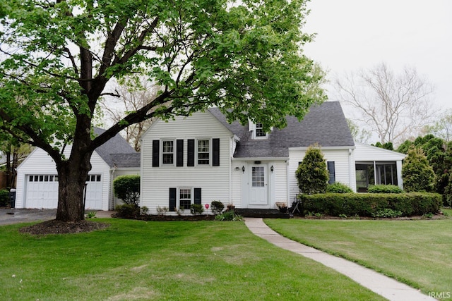 split level home with a front yard, an attached garage, roof with shingles, and aphalt driveway