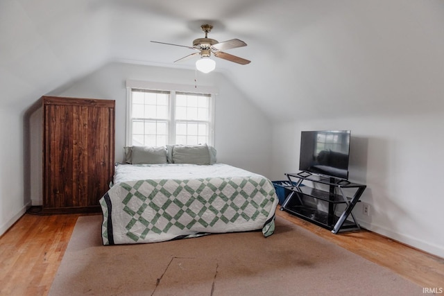 bedroom featuring wood finished floors, ceiling fan, and lofted ceiling