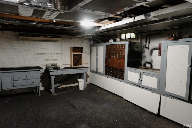 unfinished basement featuring a workshop area