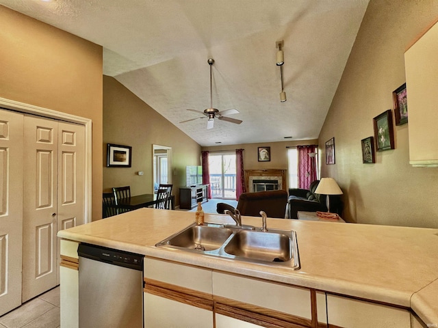 kitchen featuring dishwasher, ceiling fan, light countertops, a sink, and light tile patterned floors