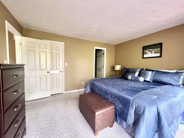carpeted bedroom with baseboards and a textured ceiling
