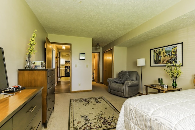bedroom with a textured ceiling, baseboards, light colored carpet, and a closet