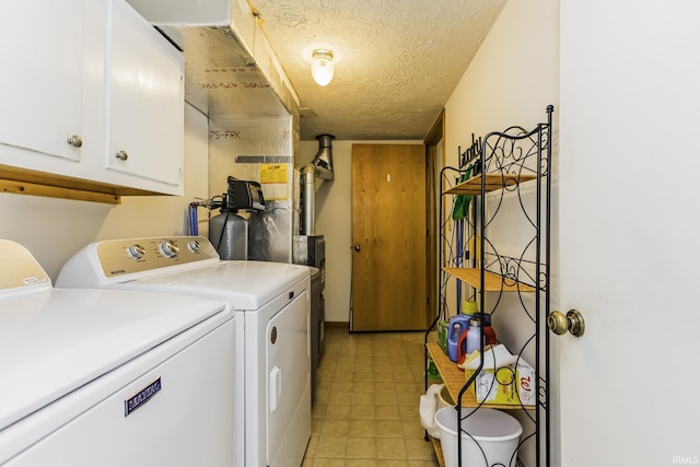 laundry area featuring cabinet space, a textured ceiling, light floors, and washer and dryer