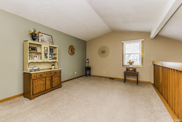bonus room featuring a textured ceiling, baseboards, vaulted ceiling, and light carpet