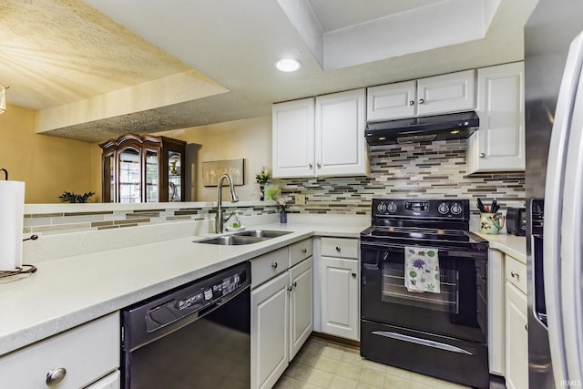 kitchen featuring a sink, white cabinetry, under cabinet range hood, and black appliances