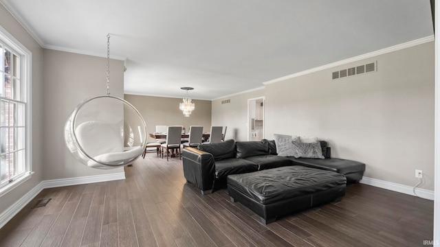 living area featuring baseboards, dark wood finished floors, a chandelier, and visible vents