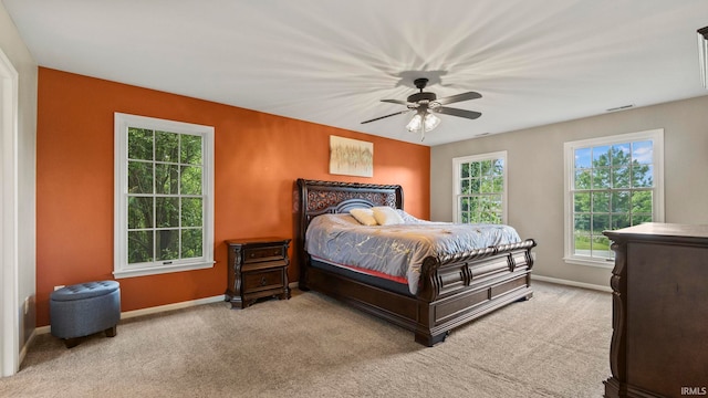 bedroom with baseboards, a ceiling fan, carpet floors, and visible vents