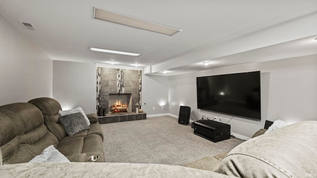 living room with visible vents, carpet flooring, baseboards, and a tile fireplace