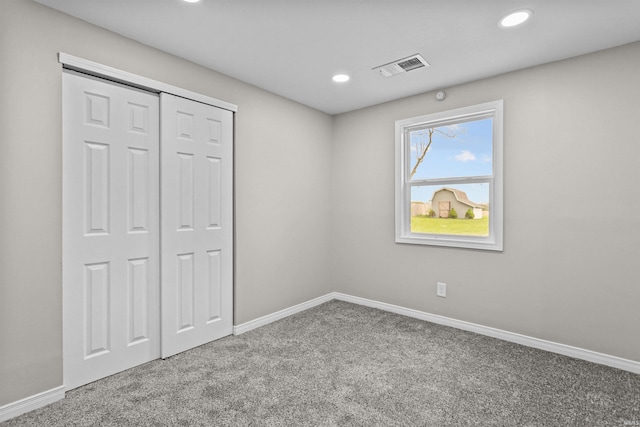 unfurnished bedroom with baseboards, carpet flooring, recessed lighting, and visible vents