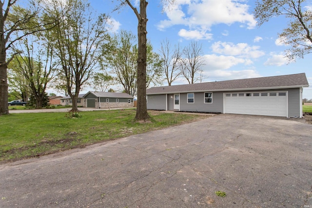 single story home with a garage, a front lawn, and aphalt driveway