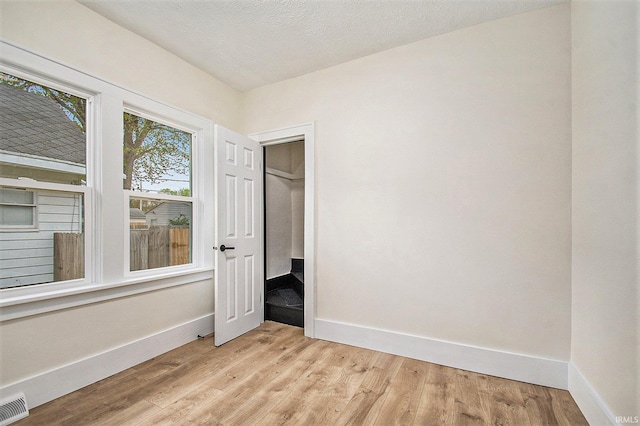 714 S 25th St, South Bend, IN 46615 - unfurnished bedroom with baseboards, light wood-type flooring, and visible vents