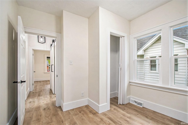 714 S 25th St, South Bend, IN 46615 - hall featuring baseboards, visible vents, and light wood-type flooring
