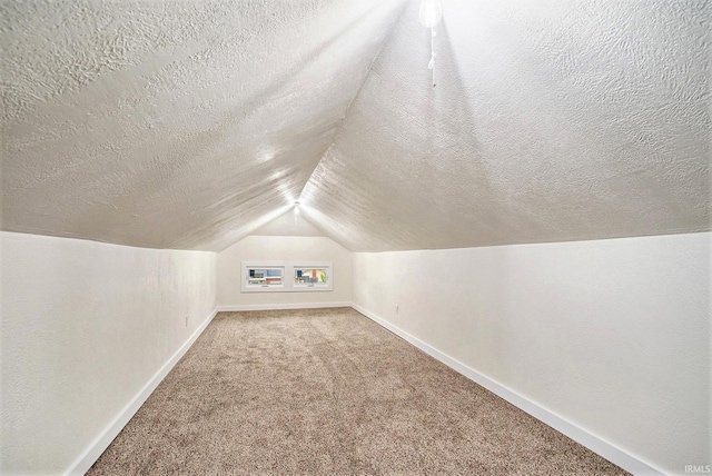 714 S 25th St, South Bend, IN 46615 - additional living space with baseboards, carpet flooring, a textured ceiling, and vaulted ceiling