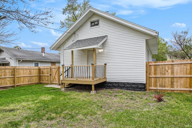 714 S 25th St, South Bend, IN 46615 - rear view of property featuring a lawn, a gate, a fenced backyard, and roof with shingles
