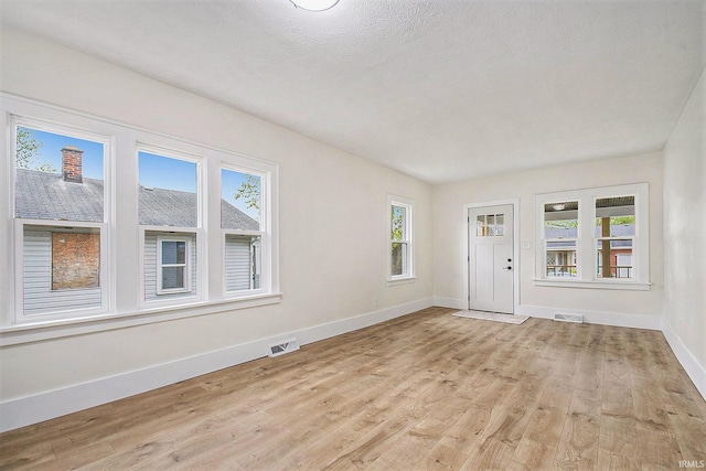 714 S 25th St, South Bend, IN 46615 - foyer entrance with visible vents, baseboards, and light wood finished floors