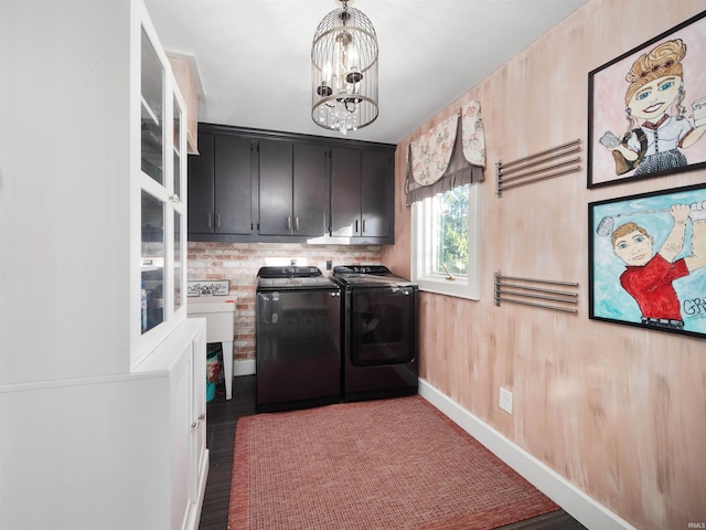 laundry room with wood finished floors, washer and dryer, baseboards, cabinet space, and a notable chandelier