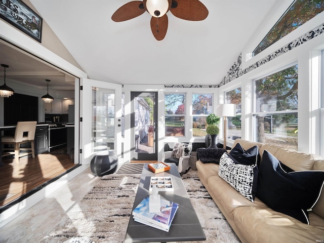 sunroom / solarium featuring high vaulted ceiling