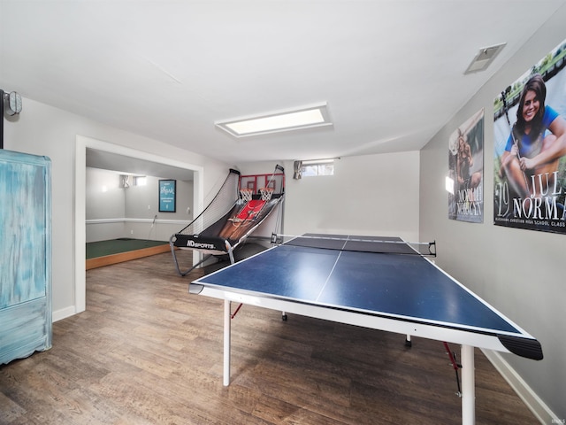 playroom featuring baseboards, visible vents, and wood finished floors