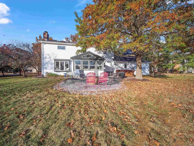 rear view of property with a lawn, a patio, a chimney, and a sunroom
