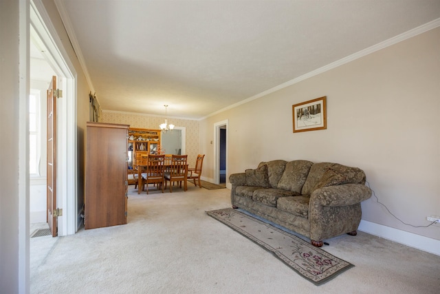 living area with carpet flooring, baseboards, an inviting chandelier, and ornamental molding