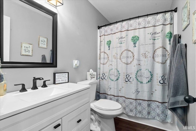 bathroom featuring vanity, curtained shower, toilet, and wood finished floors